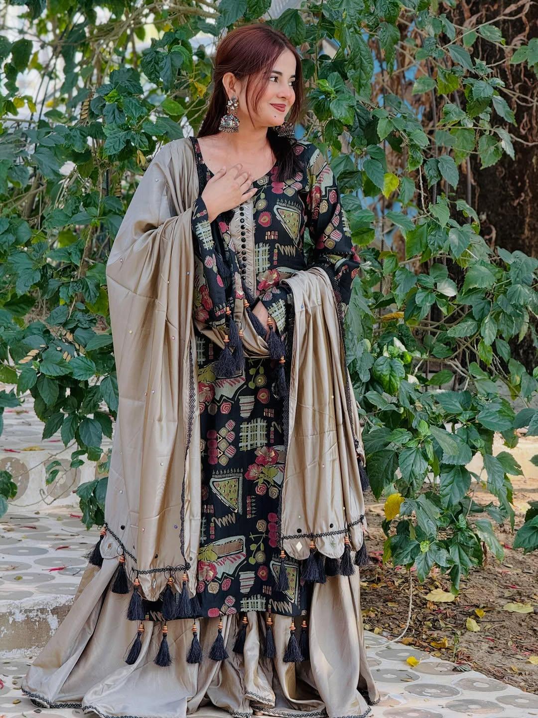 Woman in ethnic printed black and beige kurta set with tassel accents, outdoor setting