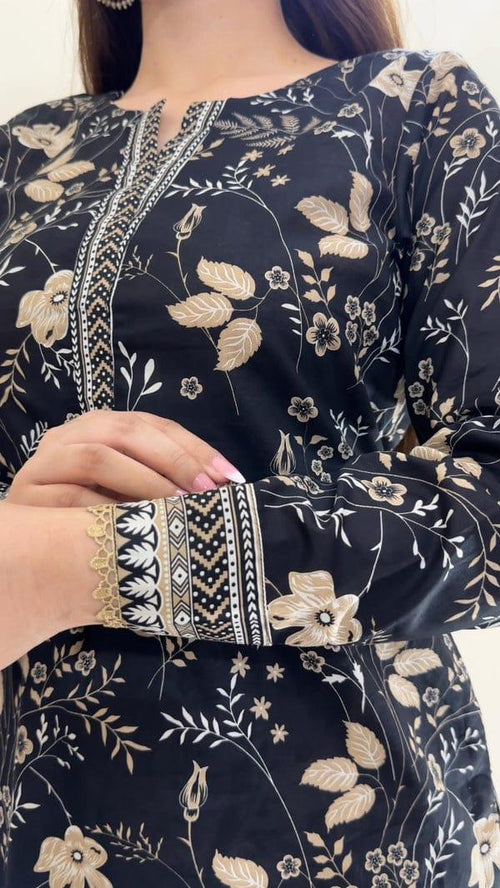 Black floral kurta with beige leaf and flower print, patterned neckline and sleeves