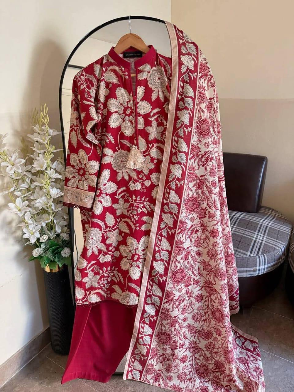 Red floral embroidered kurta set with beige dupatta, displayed on hanger indoors