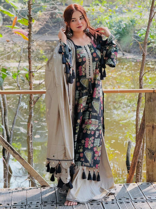 Woman wearing a floral printed ethnic dress with dupatta, standing outdoors by a pond